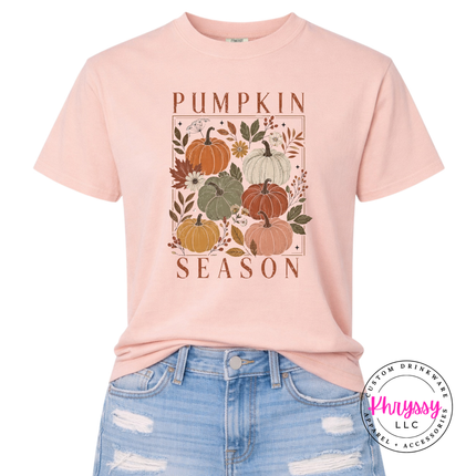 Soft Peachy tee with a hand-illustrated pumpkin season design across the chest.