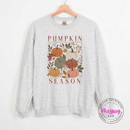 Woman wearing an Ash crewneck sweatshirt with a floral pumpkin block design.