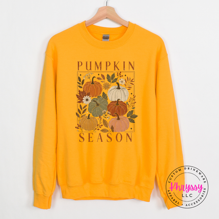 Gold crewneck sweatshirt with a muted floral pumpkin season graphic print.