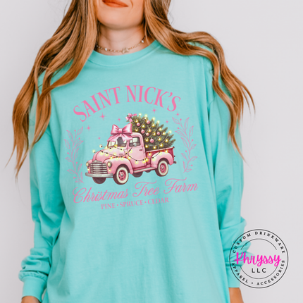 Model wearing the Saint Nick's tree farm long sleeve tee in Chalky Mint.
