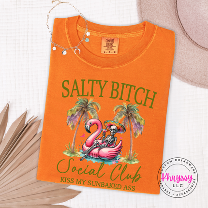 Burnt Orange t-shirt with 'Salty Bitch Social Club' design featuring a flamingo and skeleton on a white background.