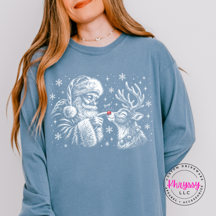 Santa giving his reindeer a nose boop on a Blue Jean long sleeve tee.