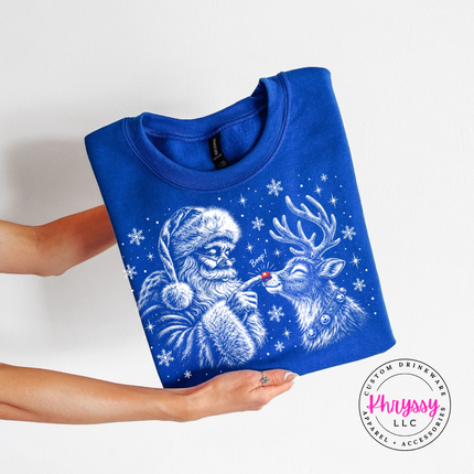 Royal crewneck sweatshirt featuring a grinning reindeer and Santa with snowflakes.