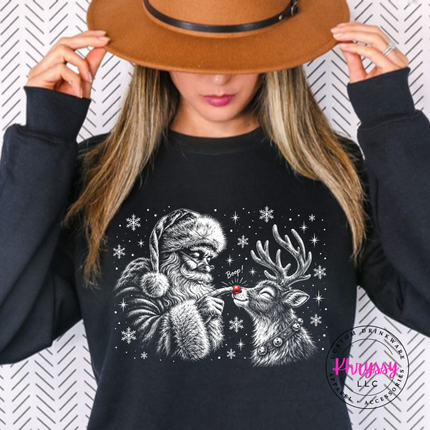 Black crewneck sweatshirt with Santa booping his reindeer on the nose.