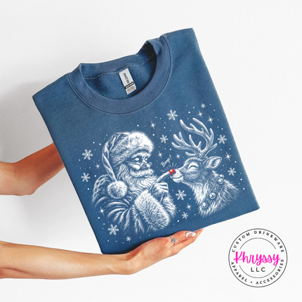 Close up of the Santa and reindeer boop sketch on an Indigo Blue crewneck sweatshirt.