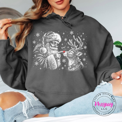 Santa giving his reindeer a nose boop on a Charcoal hoodie.