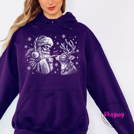 Santa giving his reindeer a nose boop on a Purple hoodie.