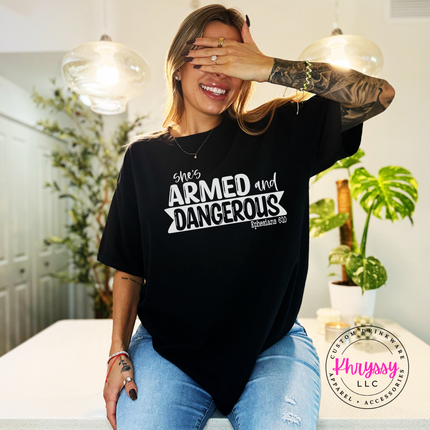 Black garment-dyed tee with a white She's Armed and Dangerous Ephesians design.