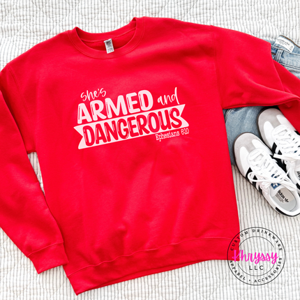 Red crewneck featuring a She's Armed and Dangerous scripture design.