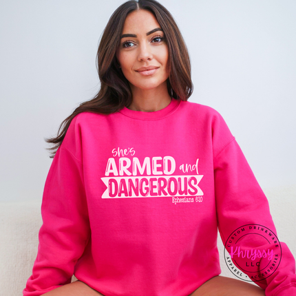 Heliconia heavyweight crewneck printed with an empowering armed and dangerous design.