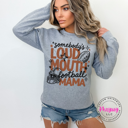 Woman wearing a Sport Grey crewneck sweatshirt with the loud mouth football mama graphic