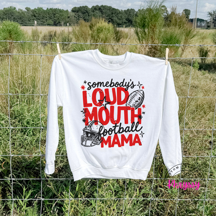White crewneck sweatshirt with the somebody's loud mouth football mama game day design