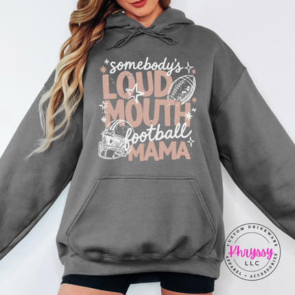 Woman wearing a Charcoal hoodie with the loud mouth football mama graphic