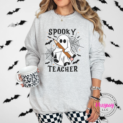 Woman wearing an Ash crewneck sweatshirt with a spooky teacher ghost design.