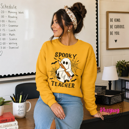 Gold crewneck sweatshirt with the spooky teacher bats and spider web print