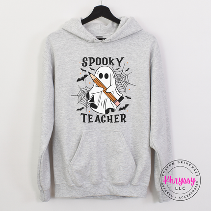 Woman wearing an Ash pullover hoodie with a spooky teacher ghost design.