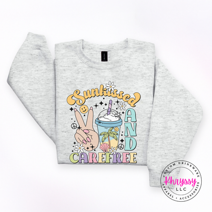 Ash crewneck sweatshirt with a pastel Sunkissed and Carefree retro summer graphic.