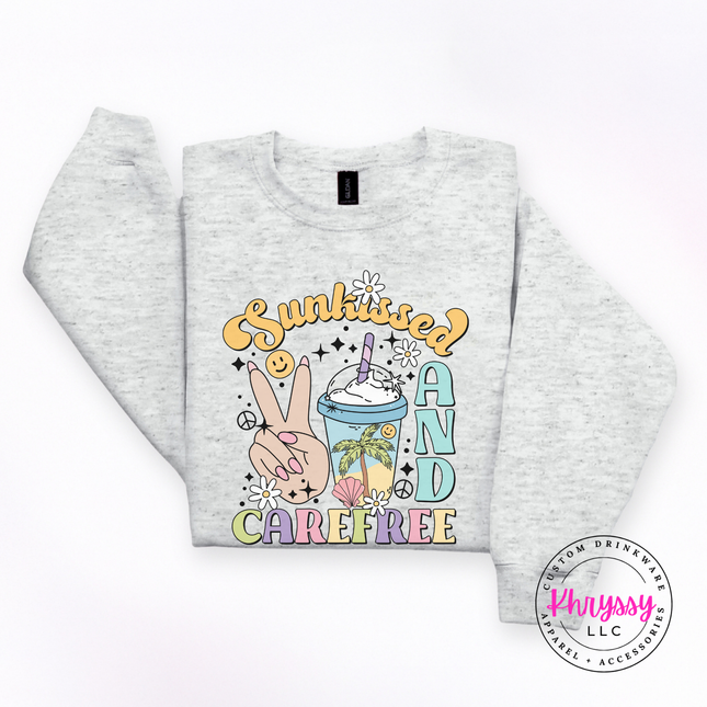 Ash crewneck sweatshirt with a pastel Sunkissed and Carefree retro summer graphic.