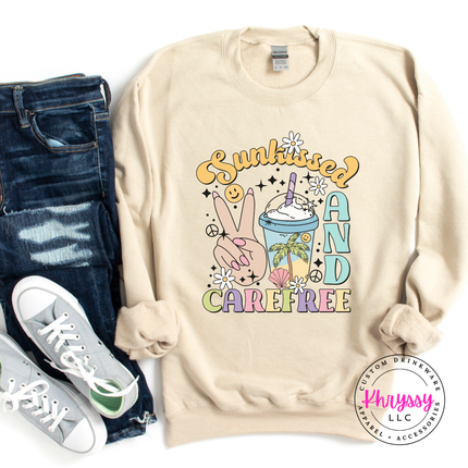 Sand crewneck sweatshirt with a pastel peace-sign and palm Sunkissed graphic.