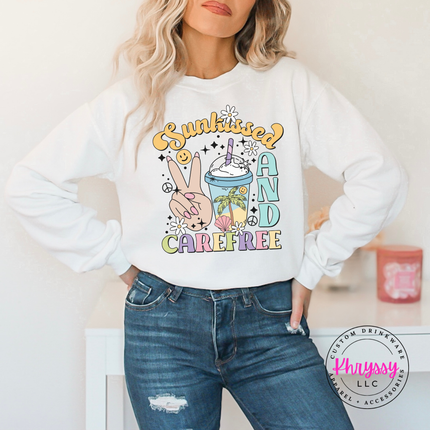 White crewneck sweatshirt displaying a retro pastel Sunkissed and Carefree design.