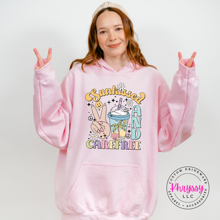 Light Pink pullover hoodie showing a retro Sunkissed and Carefree summer print.