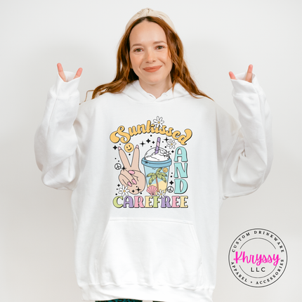 White pullover hoodie displaying a retro pastel Sunkissed and Carefree design.