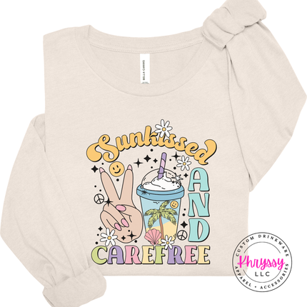 Natural long sleeve tee showing a retro Sunkissed and Carefree summer print.
