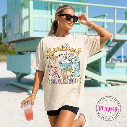 Ivory garment-dyed tee showing a retro Sunkissed and Carefree summer print.