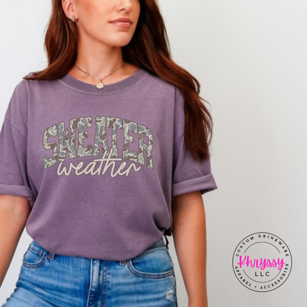 Flat lay of the Sweater Weather Christmas tee in Wine.