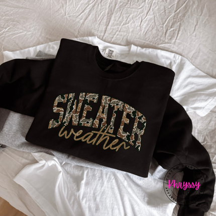 Black crewneck sweatshirt featuring camo leopard Sweater Weather lettering.