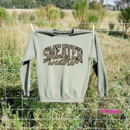 Military Green crewneck sweatshirt featuring camo leopard Sweater Weather lettering.
