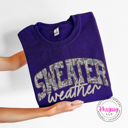 Close up of the Sweater Weather art on a Purple crewneck sweatshirt.