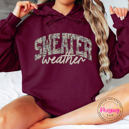 Maroon hoodie featuring camo leopard Sweater Weather lettering.