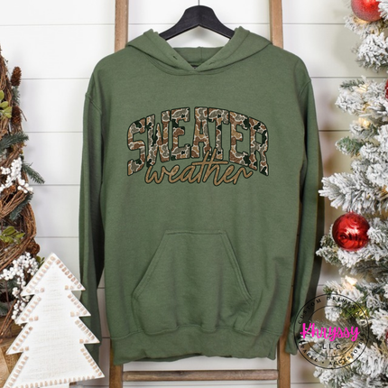 Model wearing the Sweater Weather hoodie in Military Green.