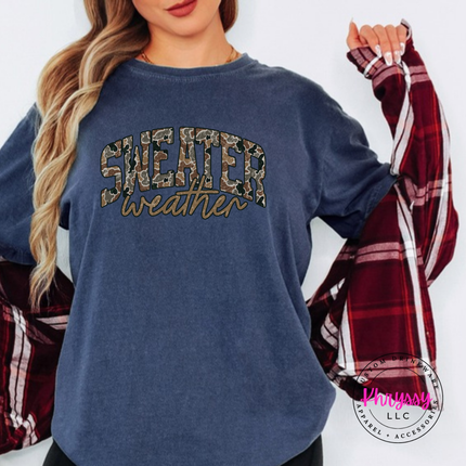 Flat lay of the Sweater Weather Christmas tee in Denim.