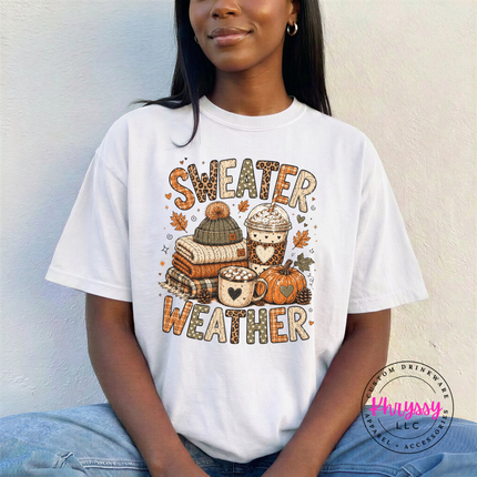 White tee featuring the autumn sweater weather graphic with coffee and books