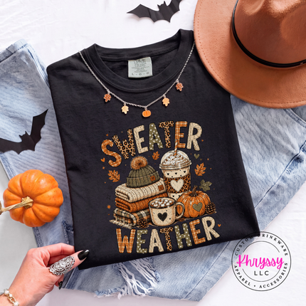 Black tee featuring the cozy sweater weather design with books and coffee