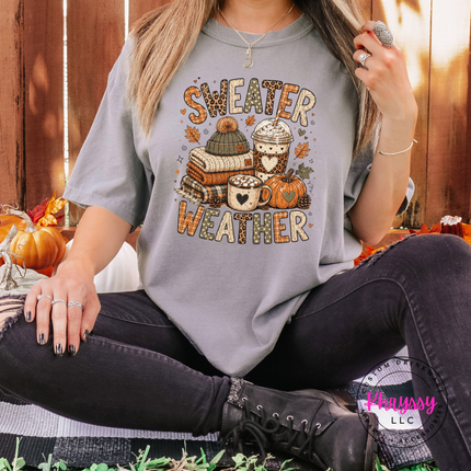 Grey tee on a hanger with the cozy sweater weather design
