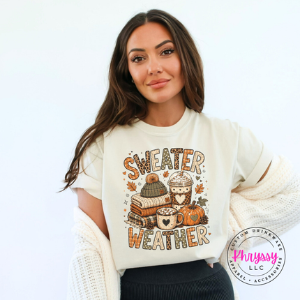 Woman wearing an Ivory tee with the sweater weather graphic and a cardigan