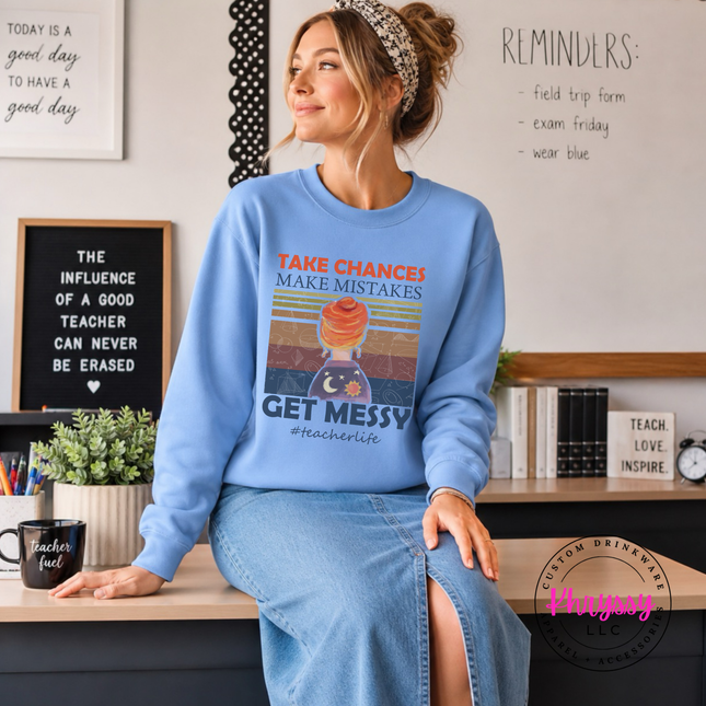 Carolina blue crewneck featuring warm sunset stripes and teacher humor.