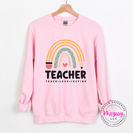 Close-up of pastel rainbow and pencil design on a Light Pink crewneck.