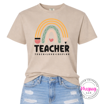 Teacher boho rainbow tee in Sandstone, styled for an everyday classroom look.