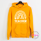 Close-up of pastel rainbow and pencil design on a Gold hoodie.