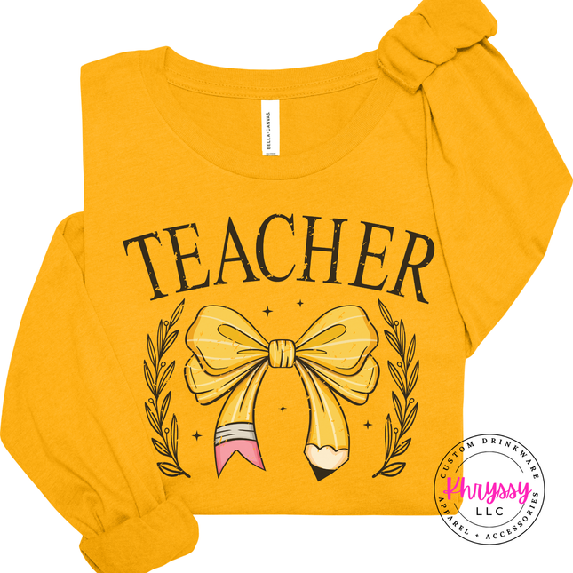 Close-up of the bow-and-pencil design and laurel leaves on a Gold tee.