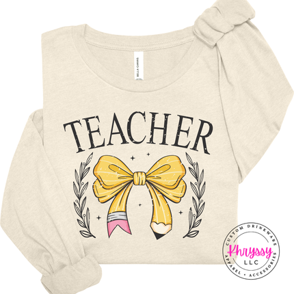 Lightweight elegant teacher tee in Natural with gold bow pencil design.