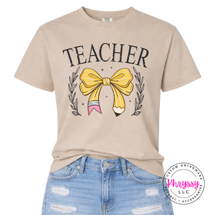 Teacher bow pencil tee in Sandstone, styled for a polished classroom look.