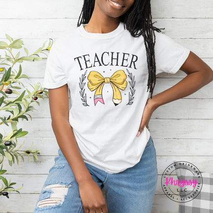 Woman wearing a White teacher bow pencil tee with gold laurel design.
