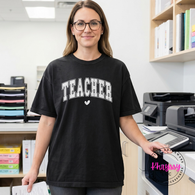 Woman wearing a Black teacher varsity arch tee holding an iced coffee.