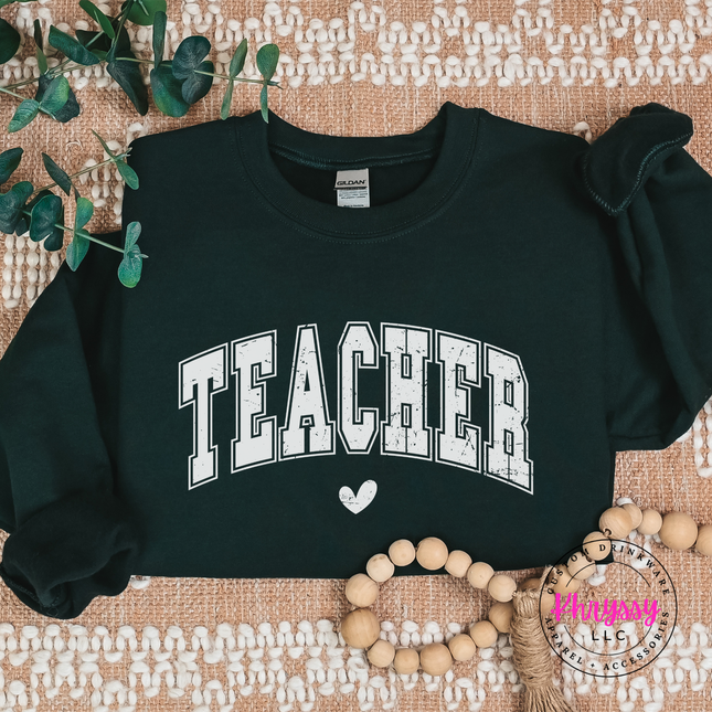 Teacher varsity sweatshirt in Forest, layered over leggings for school days.