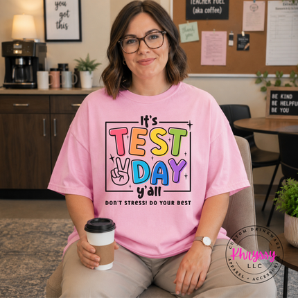Close-up of bold multicolor test day lettering on a Blossom colored tee.